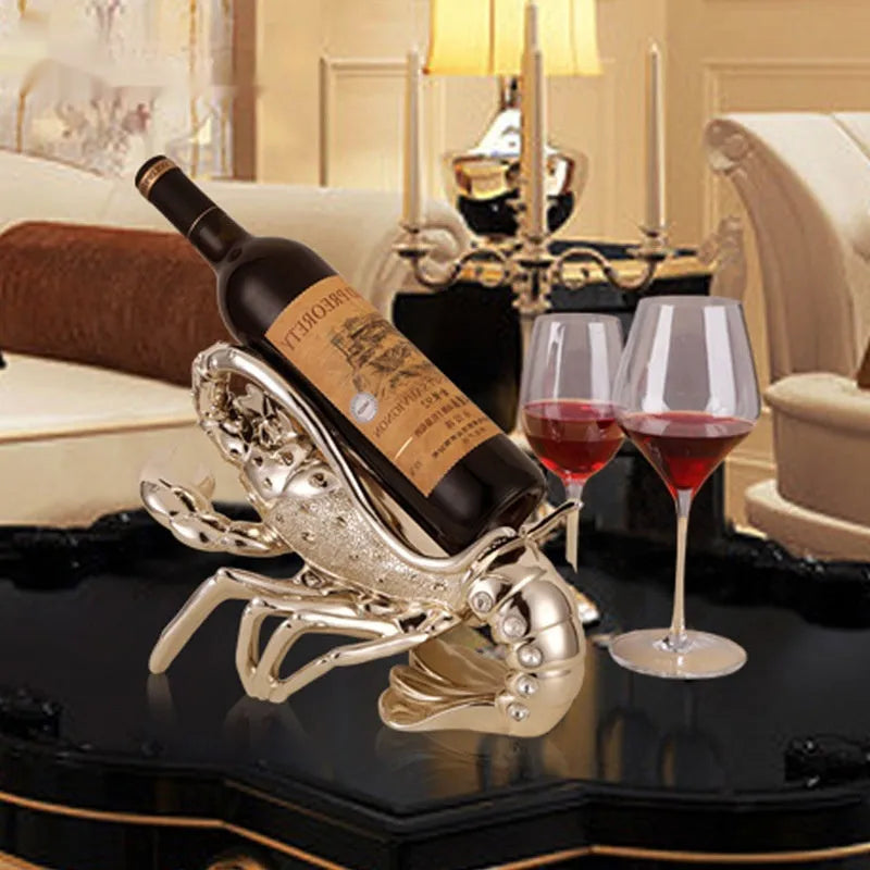 Lobster-shaped wine rack ornament in rose gold or silver resin finish on a table.