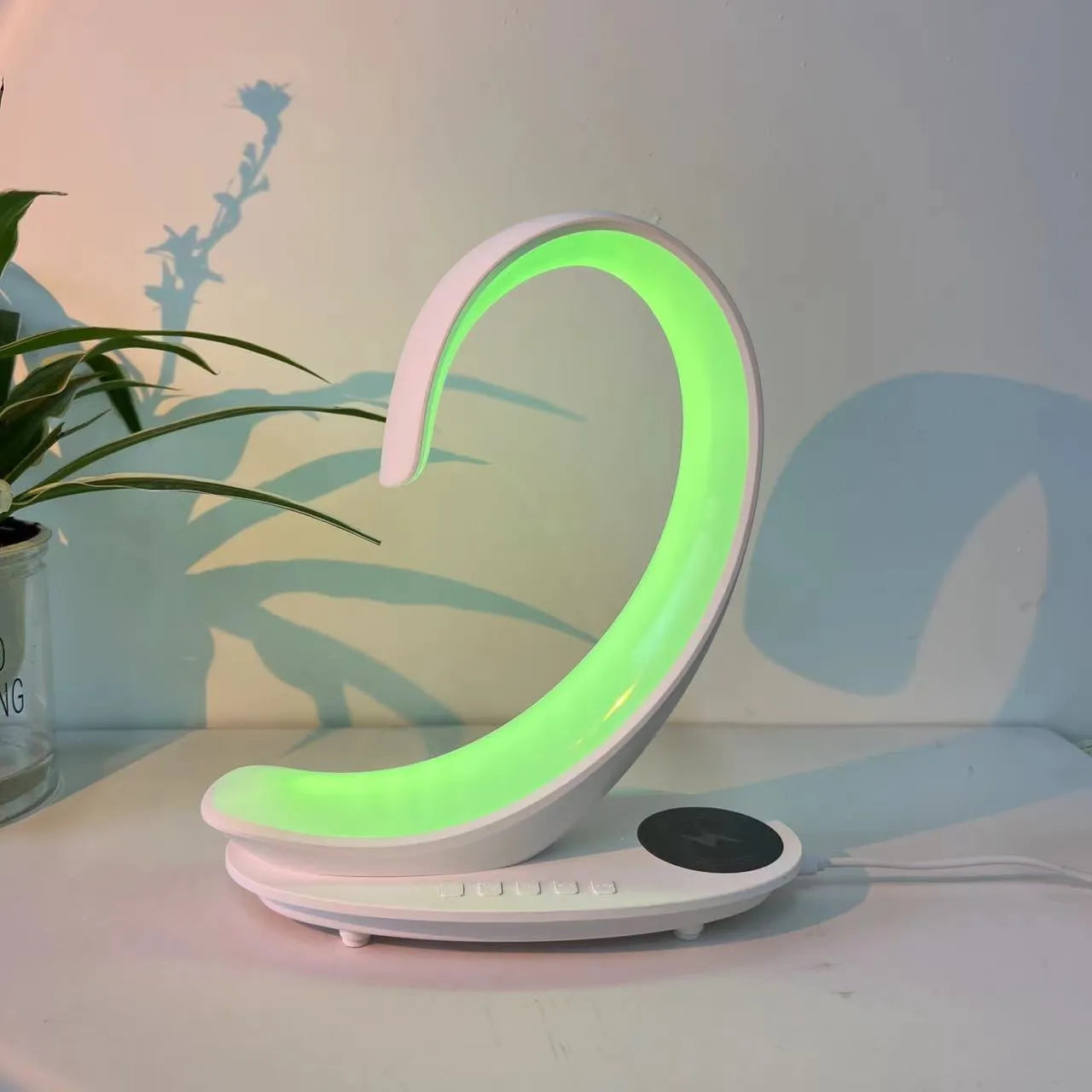 White swan shaped desk lamp with wireless charging pad and Bluetooth speaker featuring multi-colour lighting