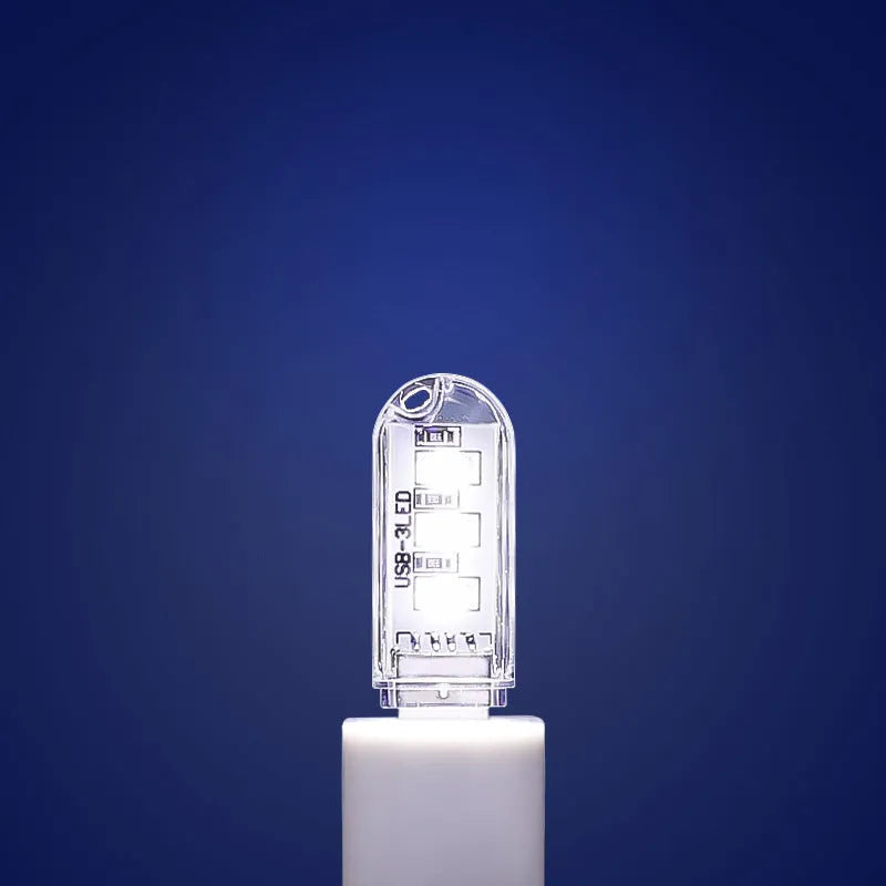 Small white USB rechargeable baby night light showing white and warm light glow options.