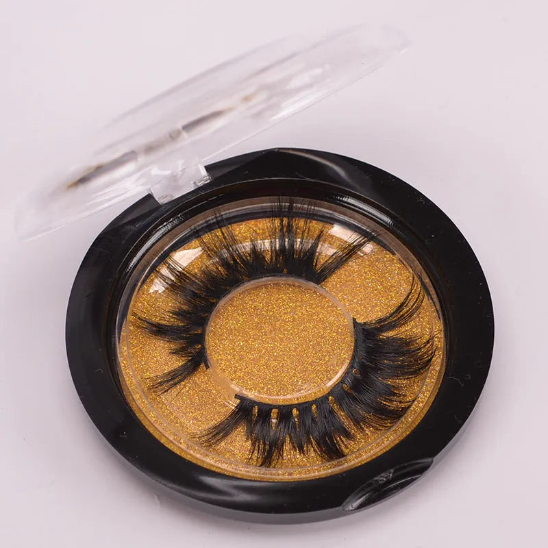 Handmade 5D mink false eyelashes set with storage case and double-headed brush on a clean background.