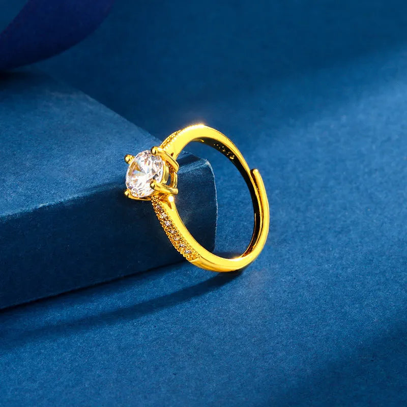Classic four-claw ring with 1 karat eight hearts eight arrows zircon in gold colour on white background