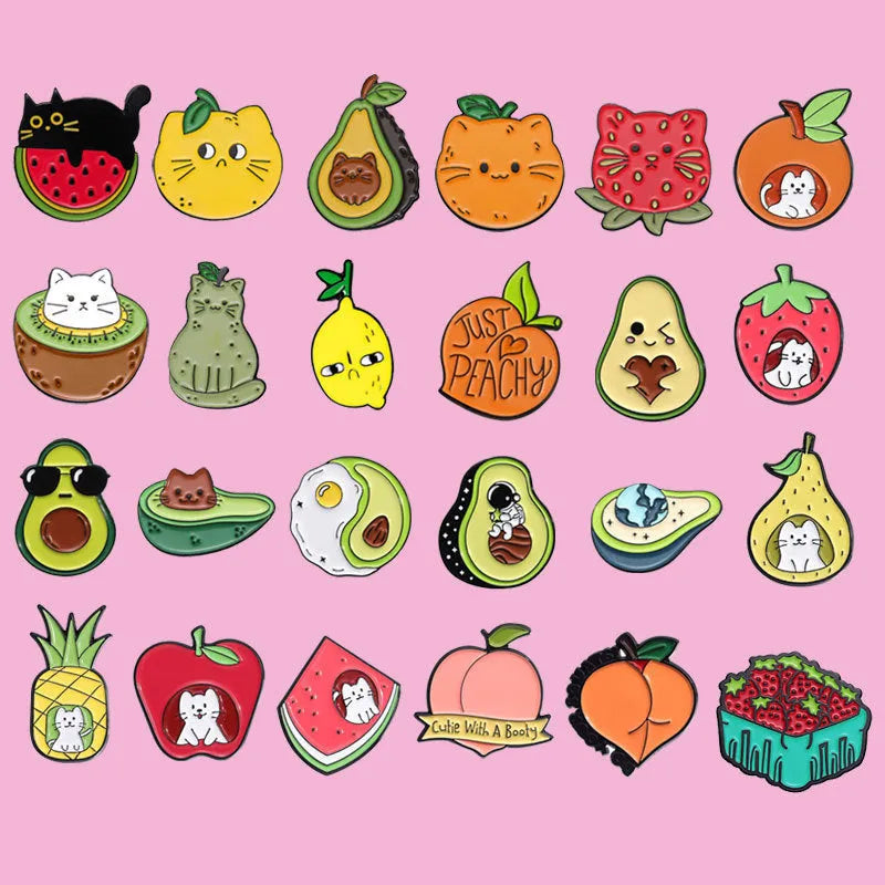 Colourful zinc alloy metal brooch with cartoon fruit and letter design on fabric.