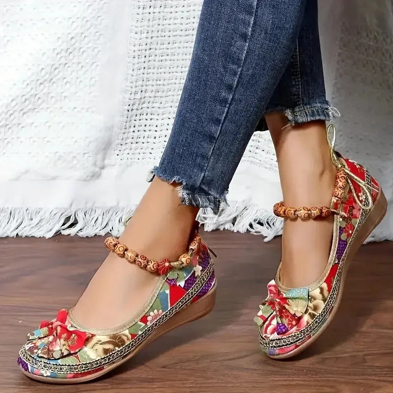 Women's black ethnic platform sandals with cloth upper and elastic band fastening on a white background.