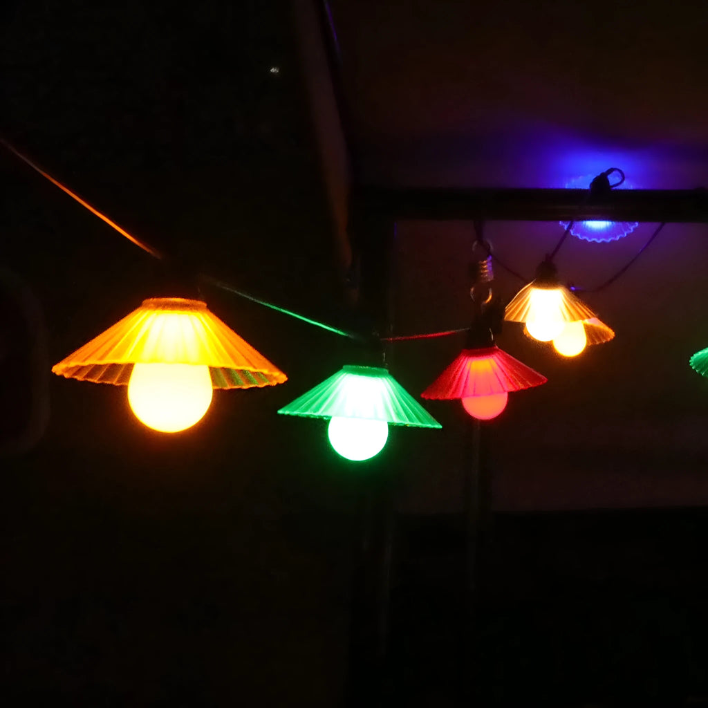 Outdoor LED string lights with flower-shaped coloured globes for garden patio decoration