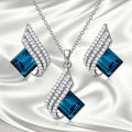 Women's necklace and earring set with glass pendant on cross chain necklace