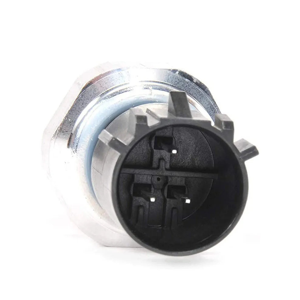 Silver automobile fuel pressure sensor with electrical connector isolated on white background.
