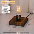 Creative iron art suspension bulb night lamp on a black wood grain desktop base.