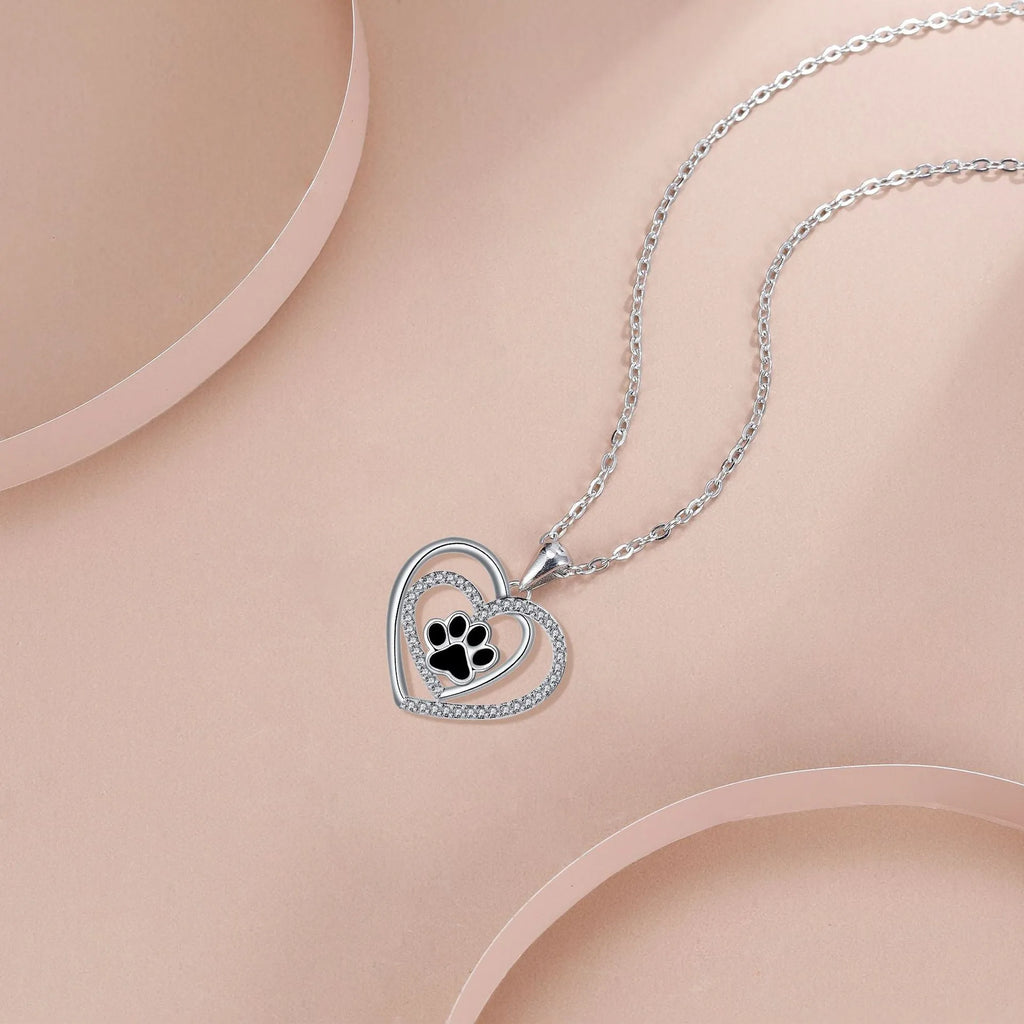 Close-up of a women's copper necklace with a heart-shaped dog's paw print pendant.