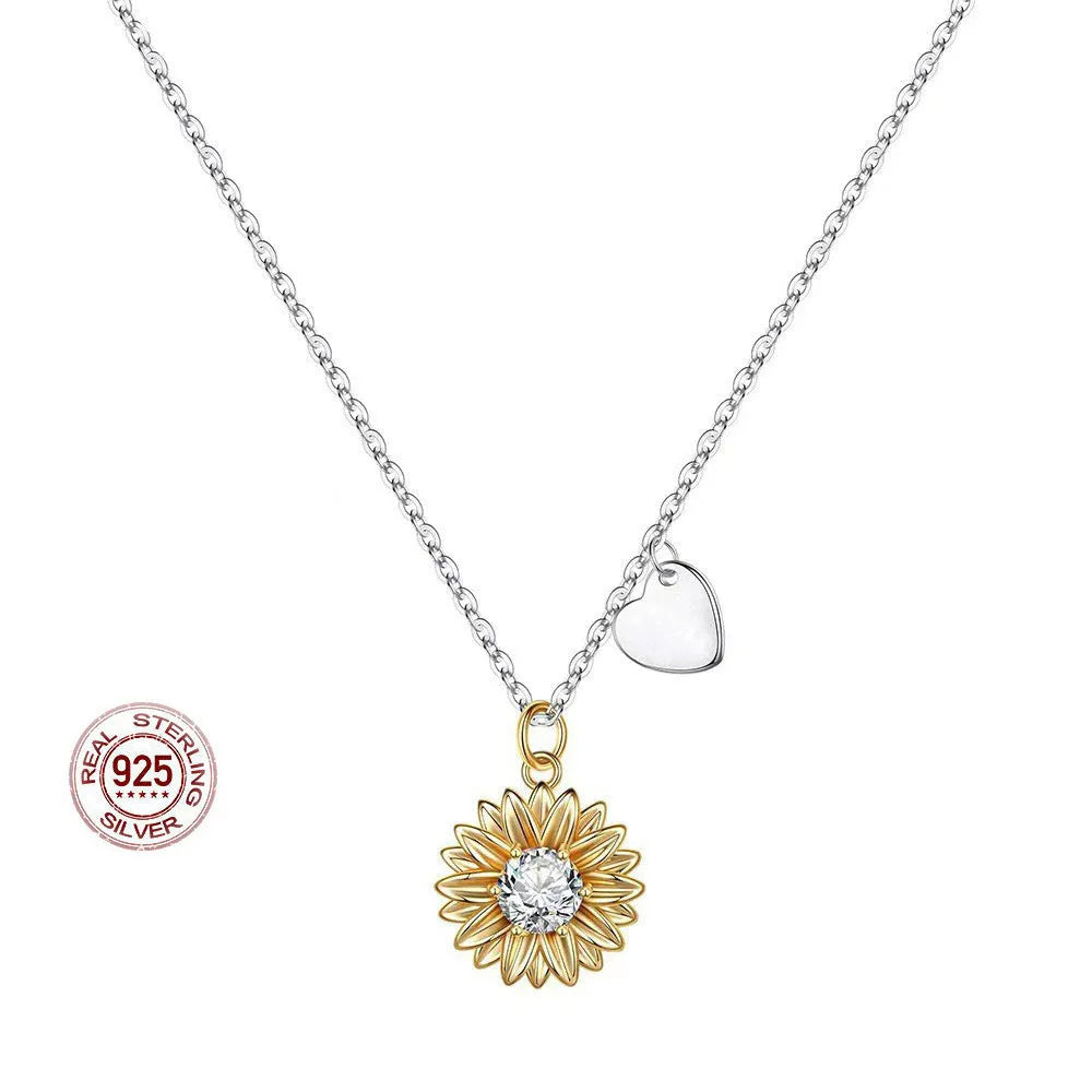 Sterling silver sunflower pendant necklace with adjustable chain on grey background