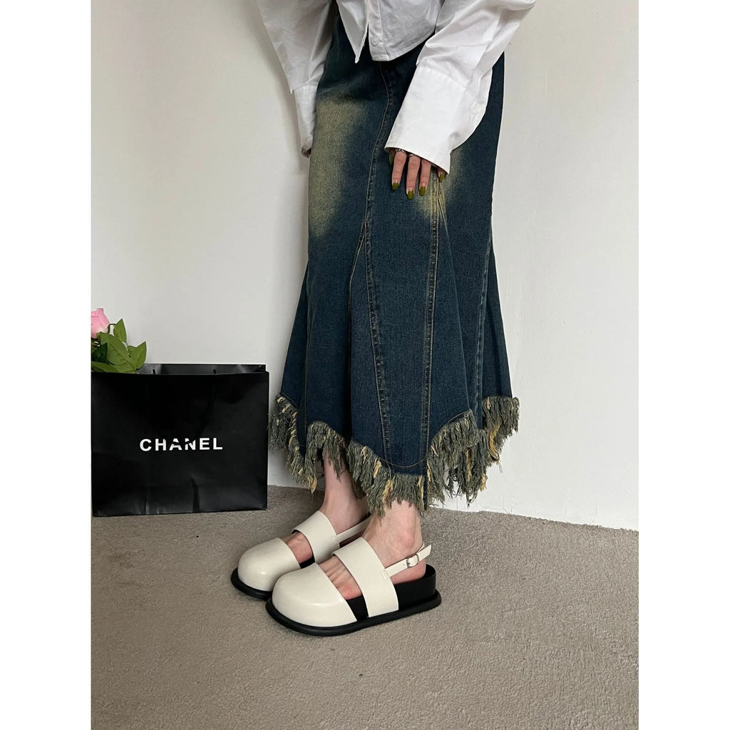 Retro closed toe sandals with an ankle buckle in apricot colour on a white background