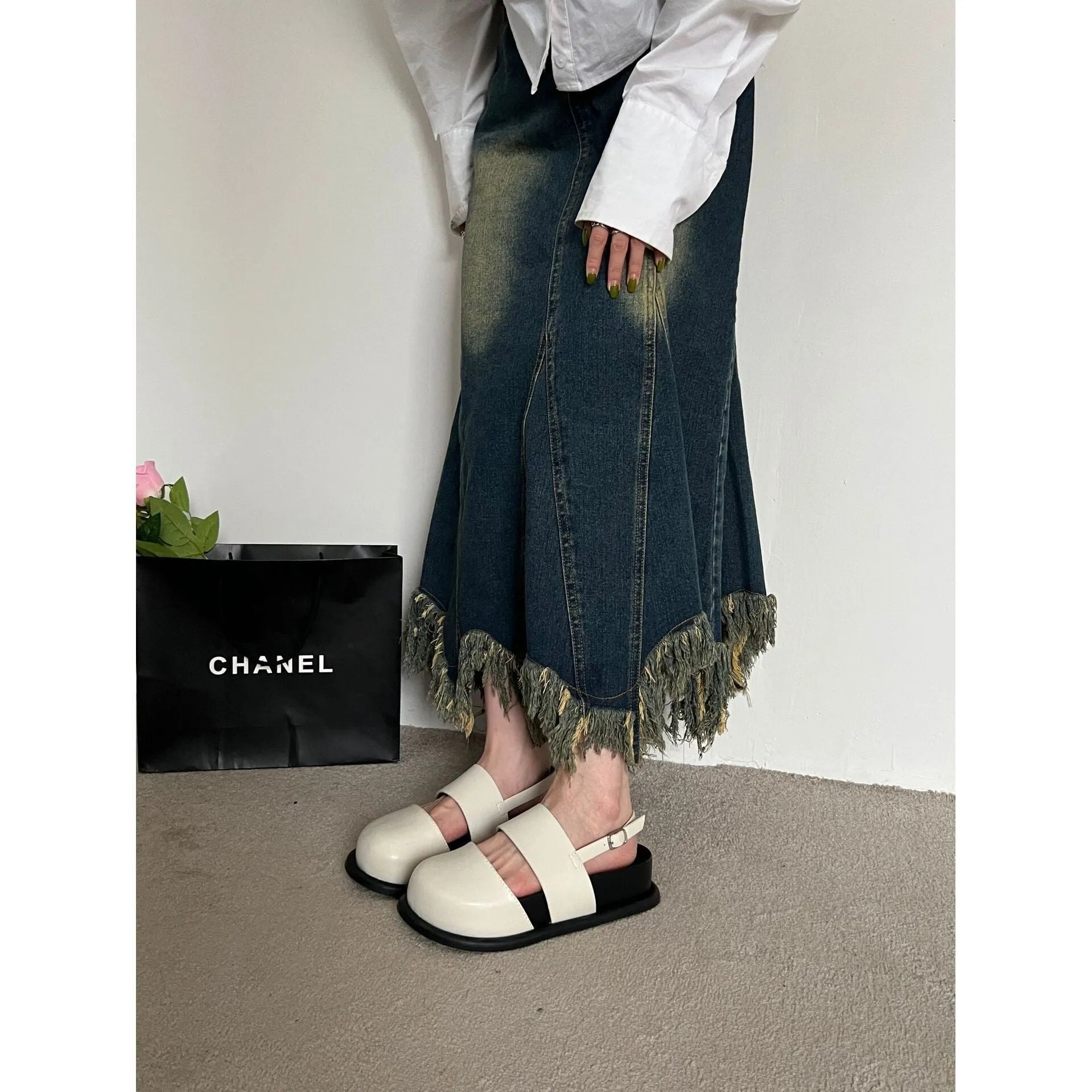 Retro closed toe sandals with an ankle buckle in apricot colour on a white background