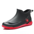 Unisex low-cut PVC rain boots in black with round toe and moulded plastic sole