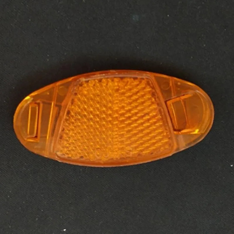 White and yellow plastic bicycle spoke reflectors with reflective warning film