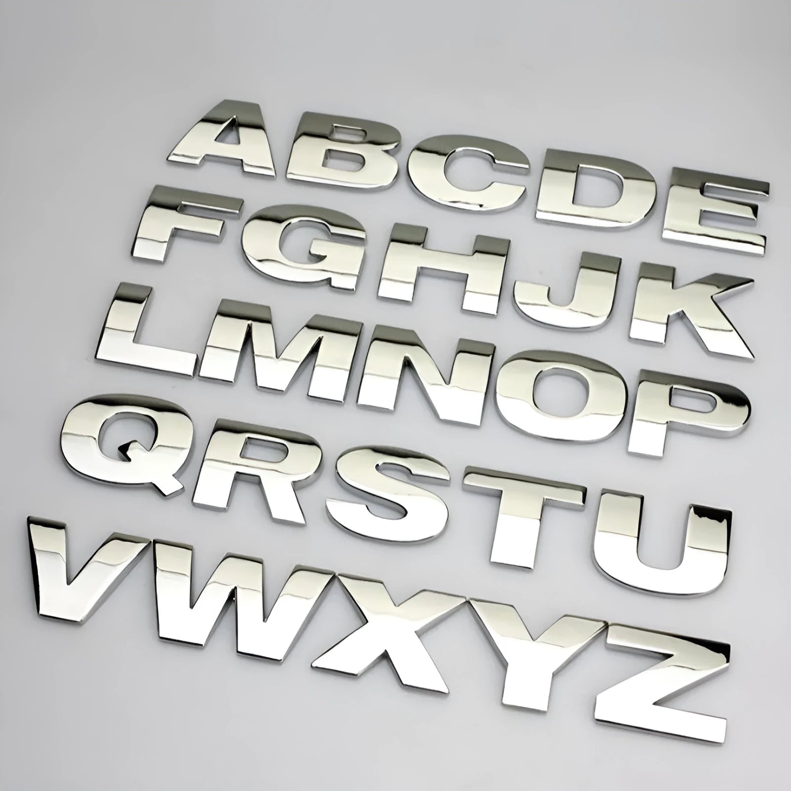 3D metal car letter stickers showing raised zinc alloy characters in black and silver finishes