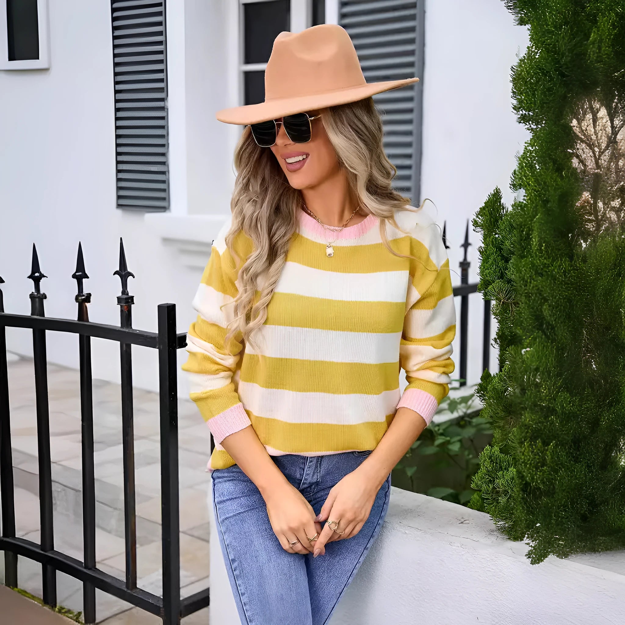 Women's loose fit long sleeve striped sweater in blue colour on a hanger.