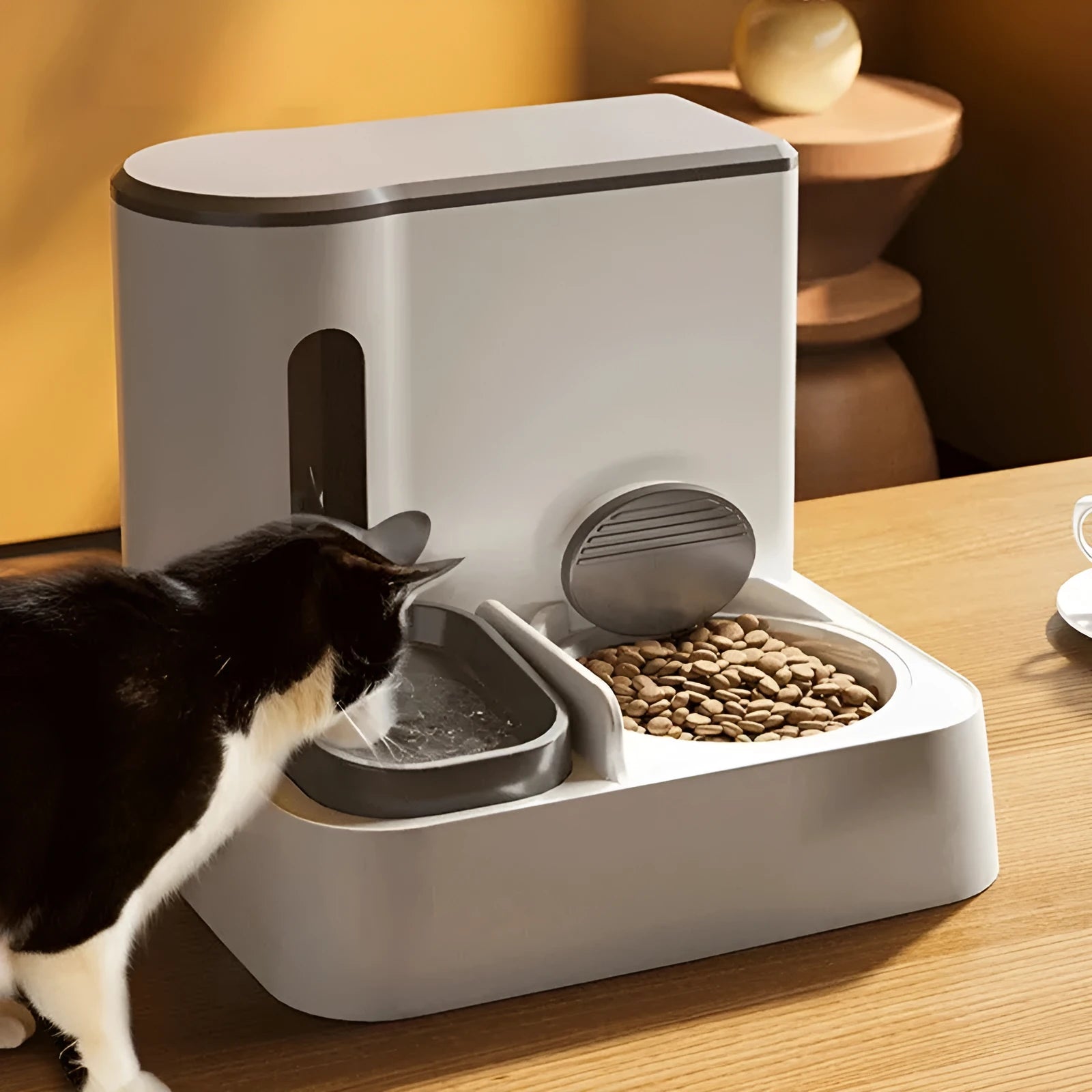 Grey automatic cat feeder with integrated water dispenser and double bowl design