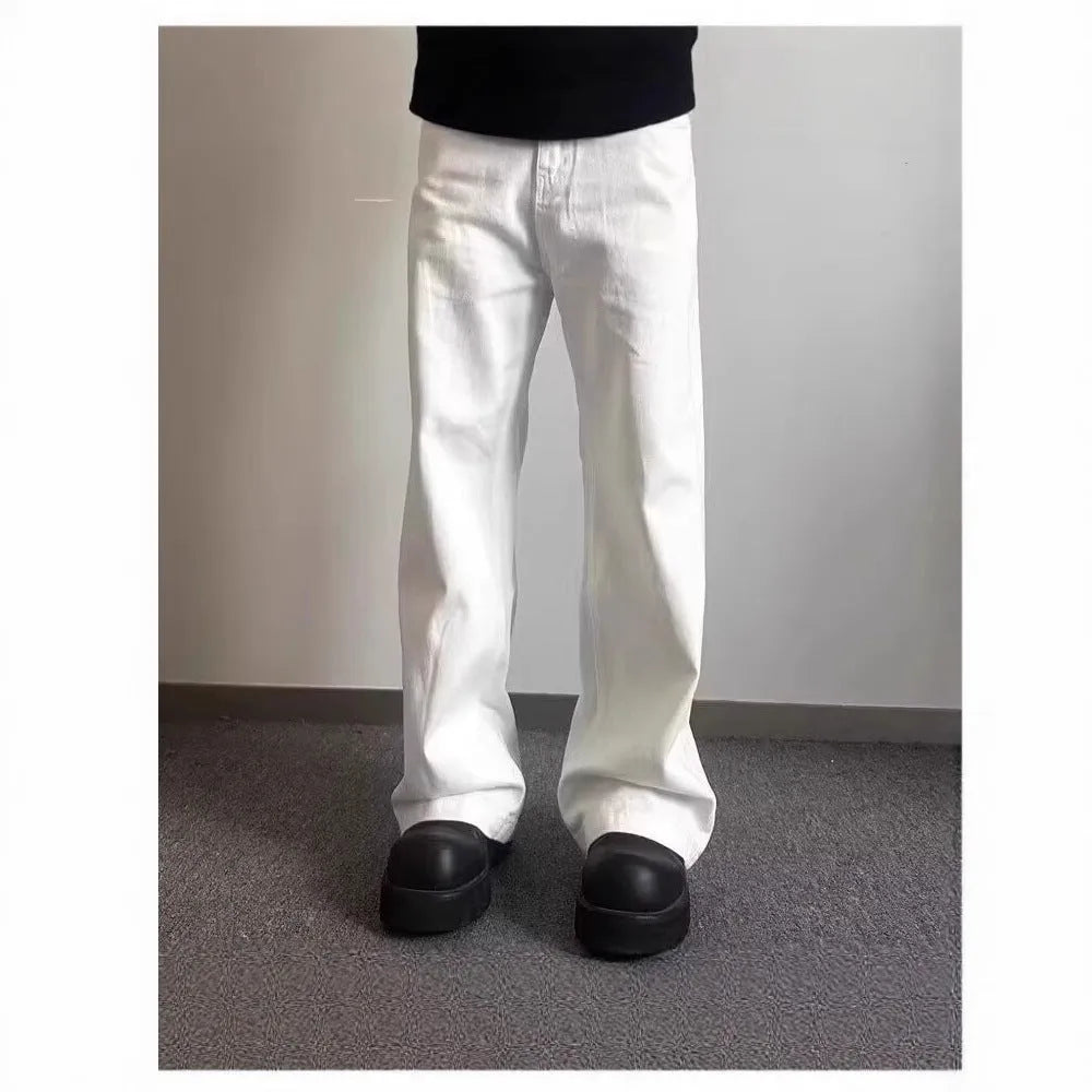 Men's white straight-leg cotton denim jeans on a hanger, showing front view with zipper fly.