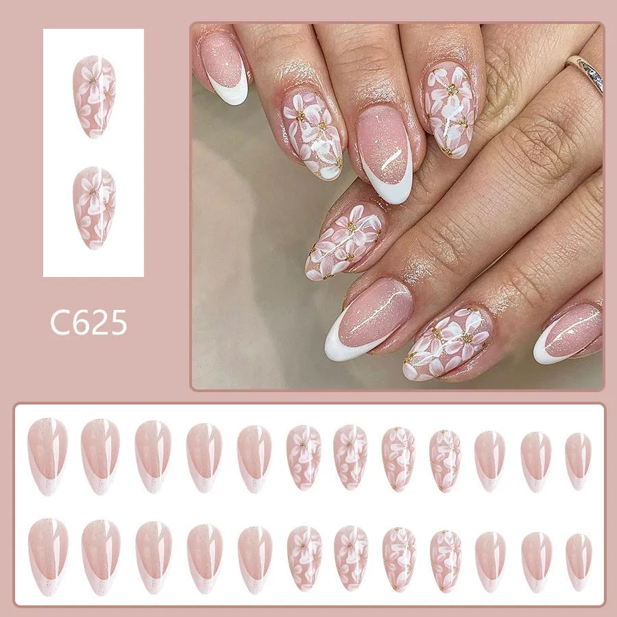 Short almond French manicure press-on nails with pink glitter finish and floral designs