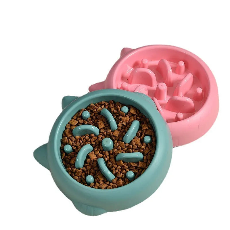 Green plastic slow feeder dog bowl with raised bone-shaped ridges inside.