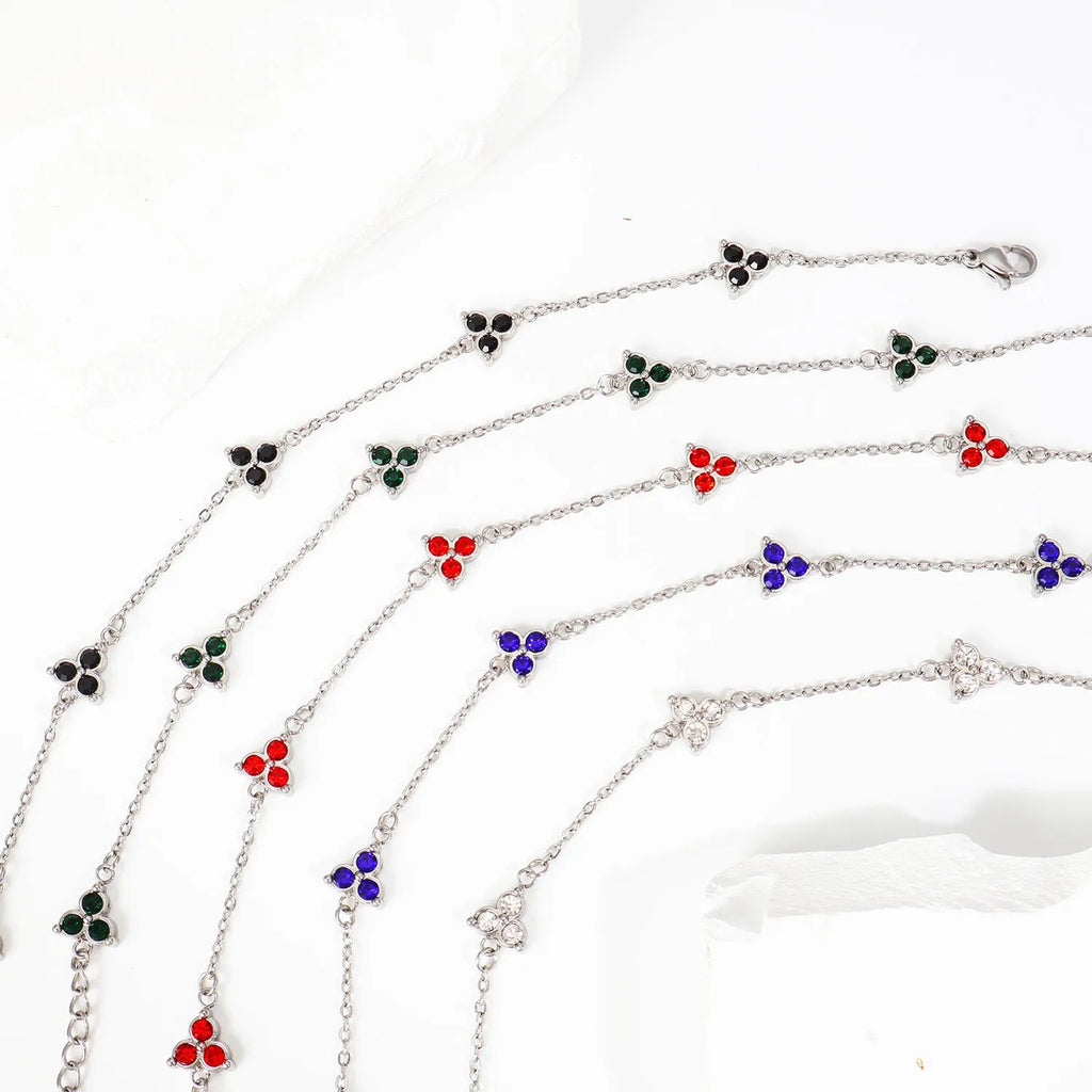 Women's geometric stainless steel bracelet with triangular diamond elements in gold or steel finish with coloured stones.