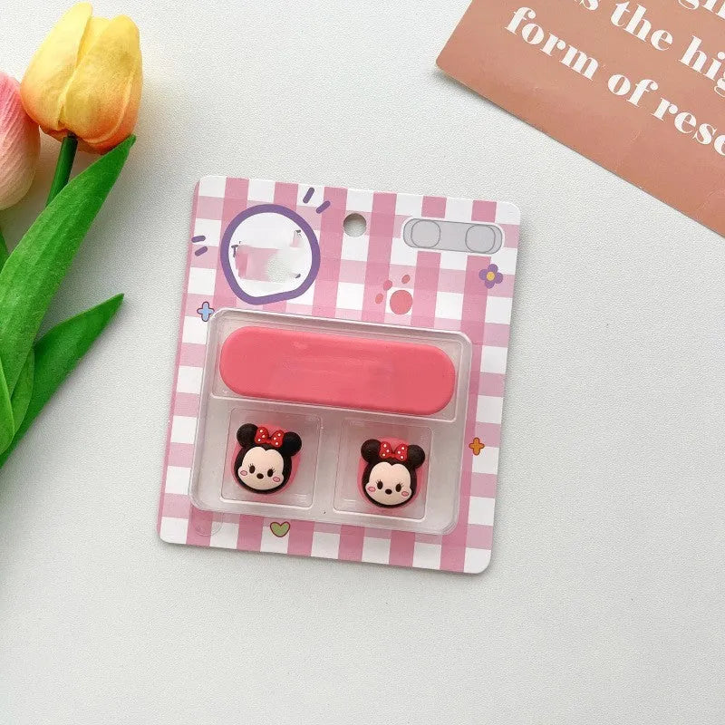 Cartoon magnetic protection data cable fixer in assorted colours on a desktop.
