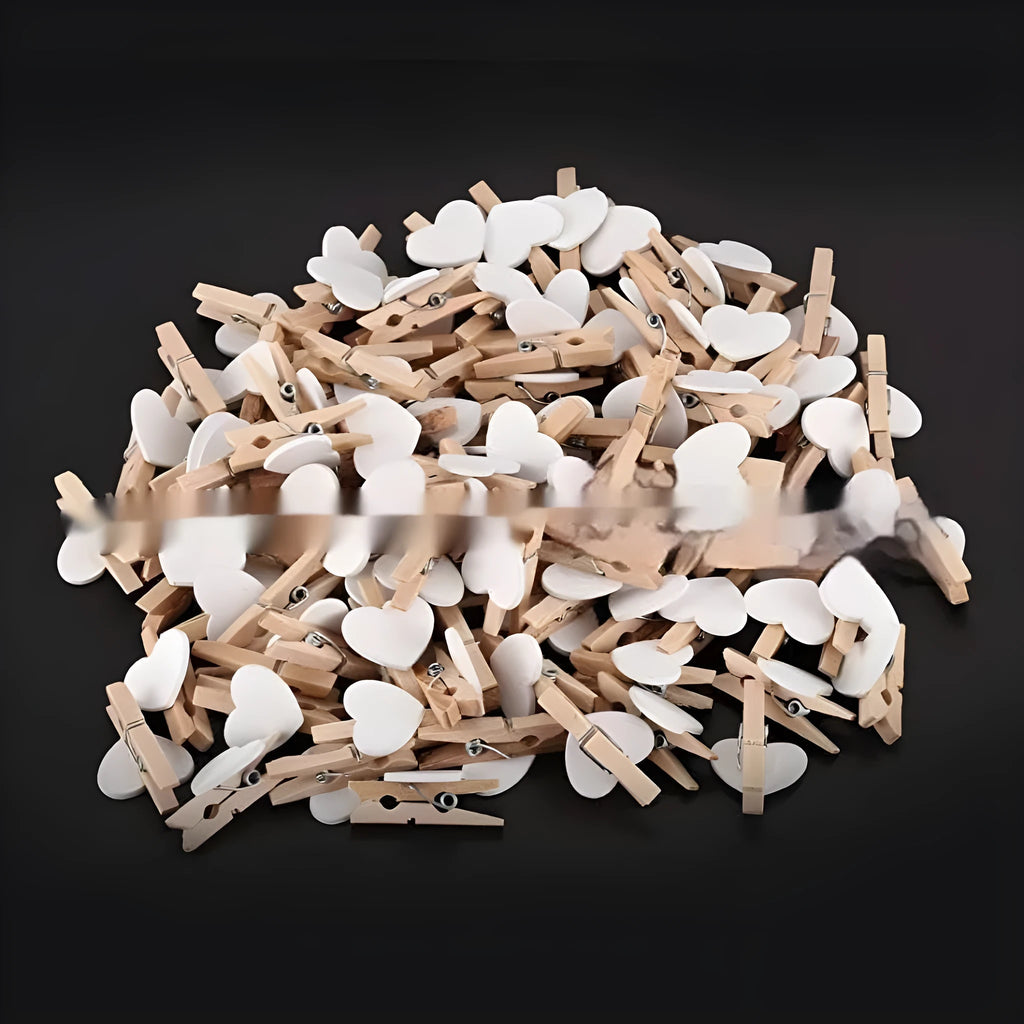 Five wooden heart-shaped hair clips in different colours on white background