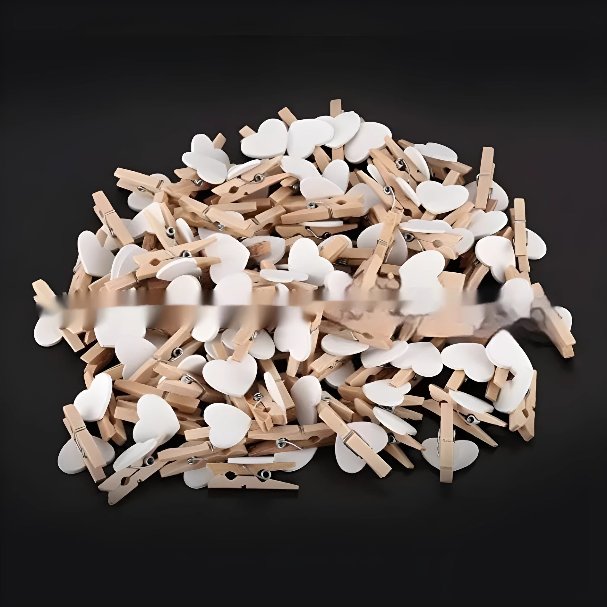 Five wooden heart-shaped hair clips in different colours on white background
