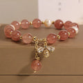 Women's strawberry quartz and freshwater pearl bracelet with zircon details and alloy charms