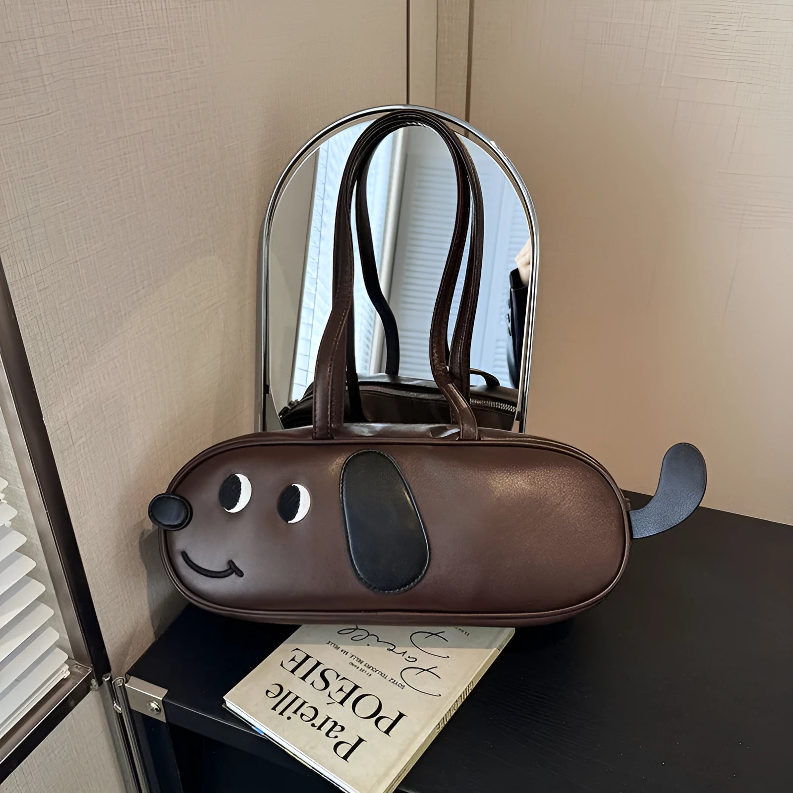 Sausage dog crossbody bag in coffee brown matte finish with single shoulder strap and horizontal shape