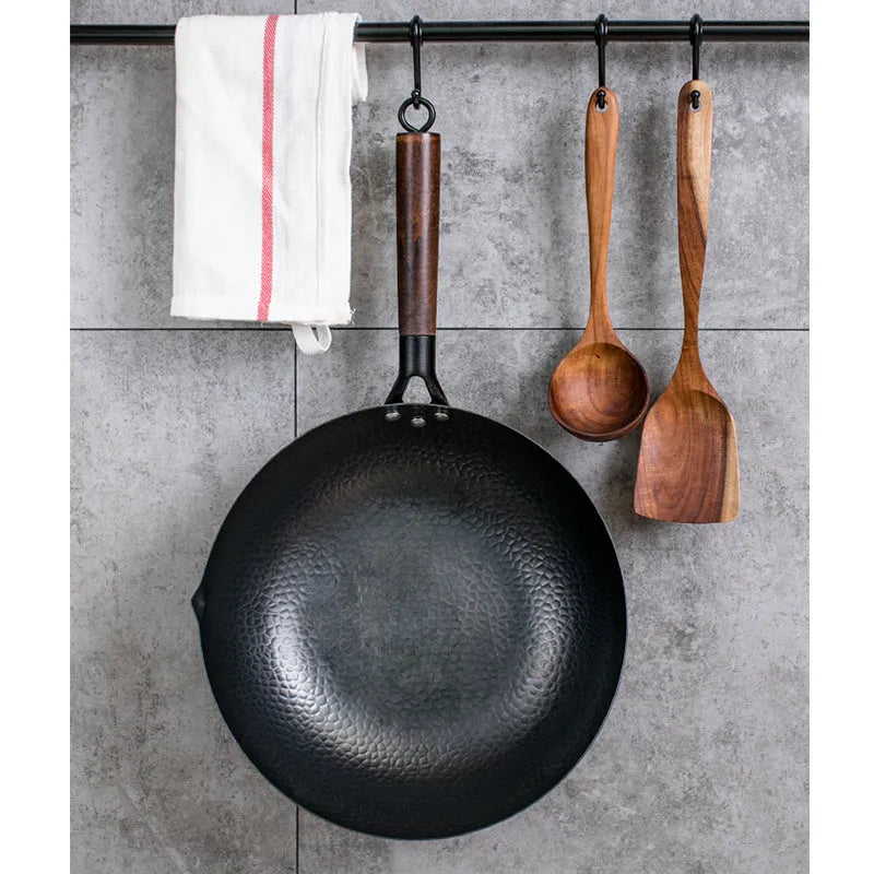 Traditional black iron wok with wooden handle measuring 32cm cooking surface diameter