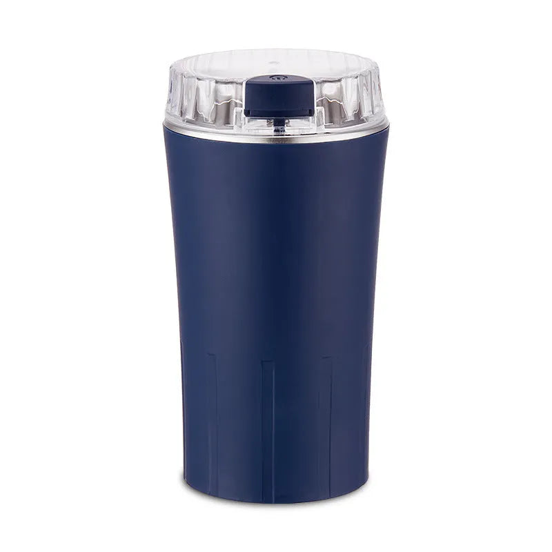 Blue mini electric flour mill and spice grinder with stainless steel grinding chamber.
