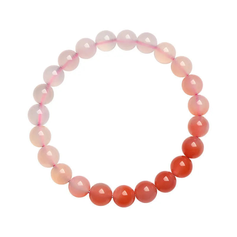Natural gradient Yanyuan agate bracelet with smooth geometric beads on a wrist.