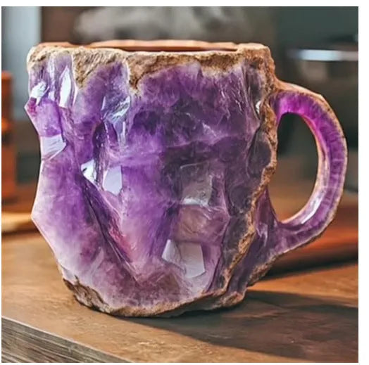 Purple and blue resin coffee mug with crystal texture and handle on wooden table