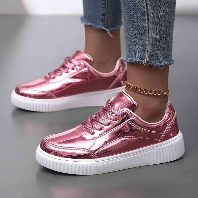 Gold sequinned platform sneakers with thick sole and round toe on a neutral background.