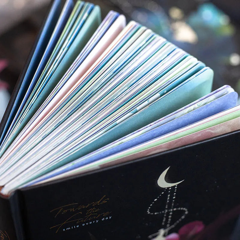 A5 notebook with luminous cover showing colour illustrations on open pages