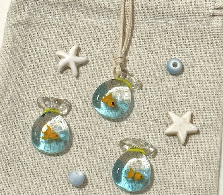 Women's joker pendant necklace with coloured glaze ornament on a cotton and linen clavicle chain.