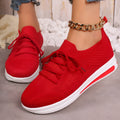 Women's red fly-knit casual sneakers with round toe and lace-up front on a white background