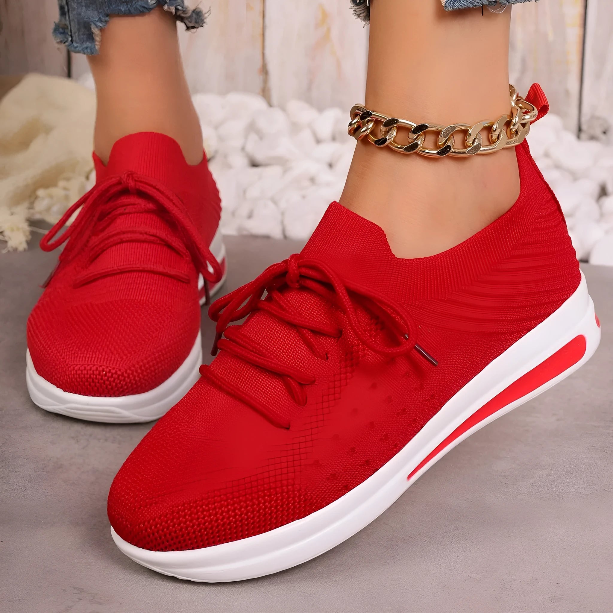 Women's red fly-knit casual sneakers with round toe and lace-up front on a white background