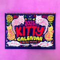 Cat themed wall calendar for 2024 or 2025, showing full year layout on paper.