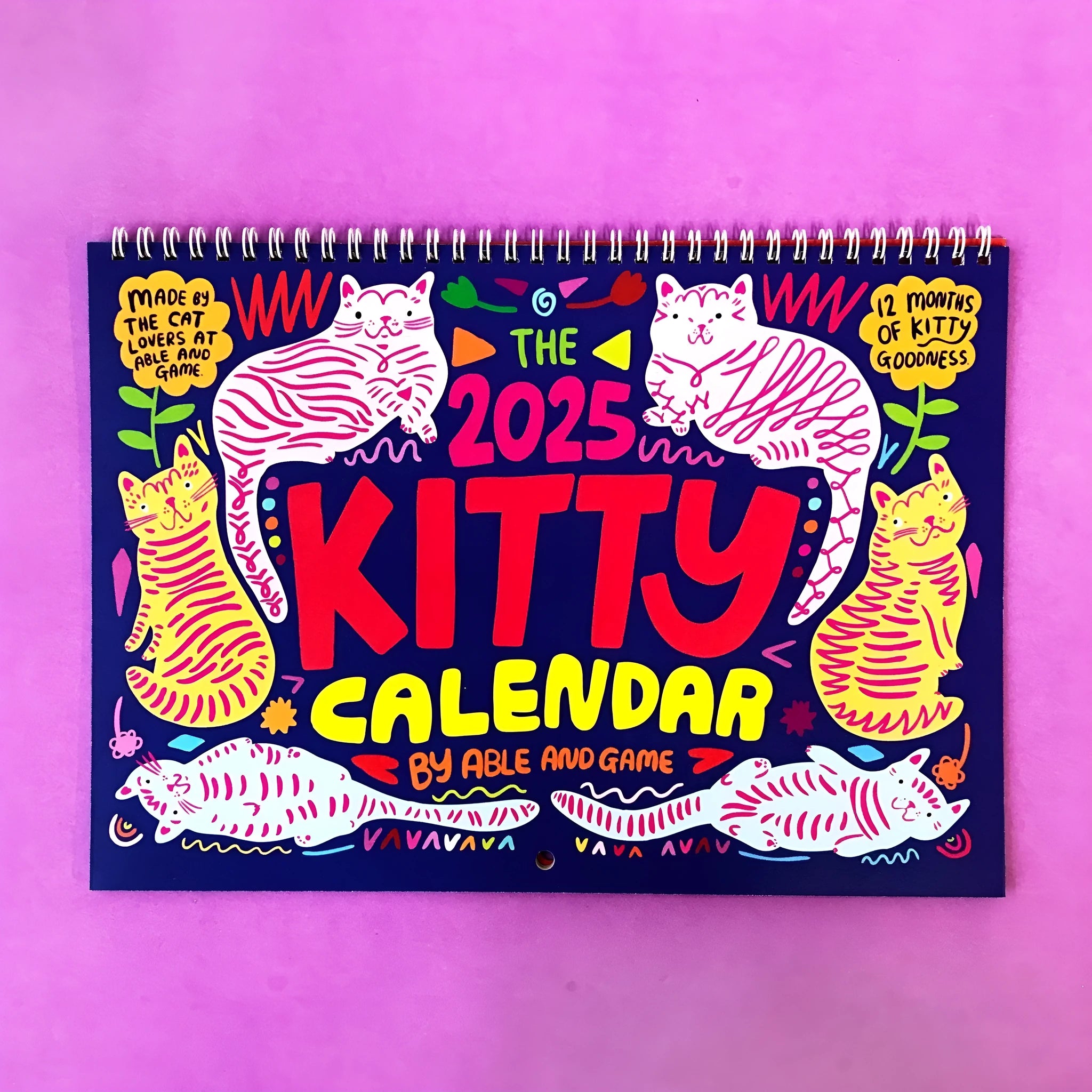 Cat themed wall calendar for 2024 or 2025, showing full year layout on paper.