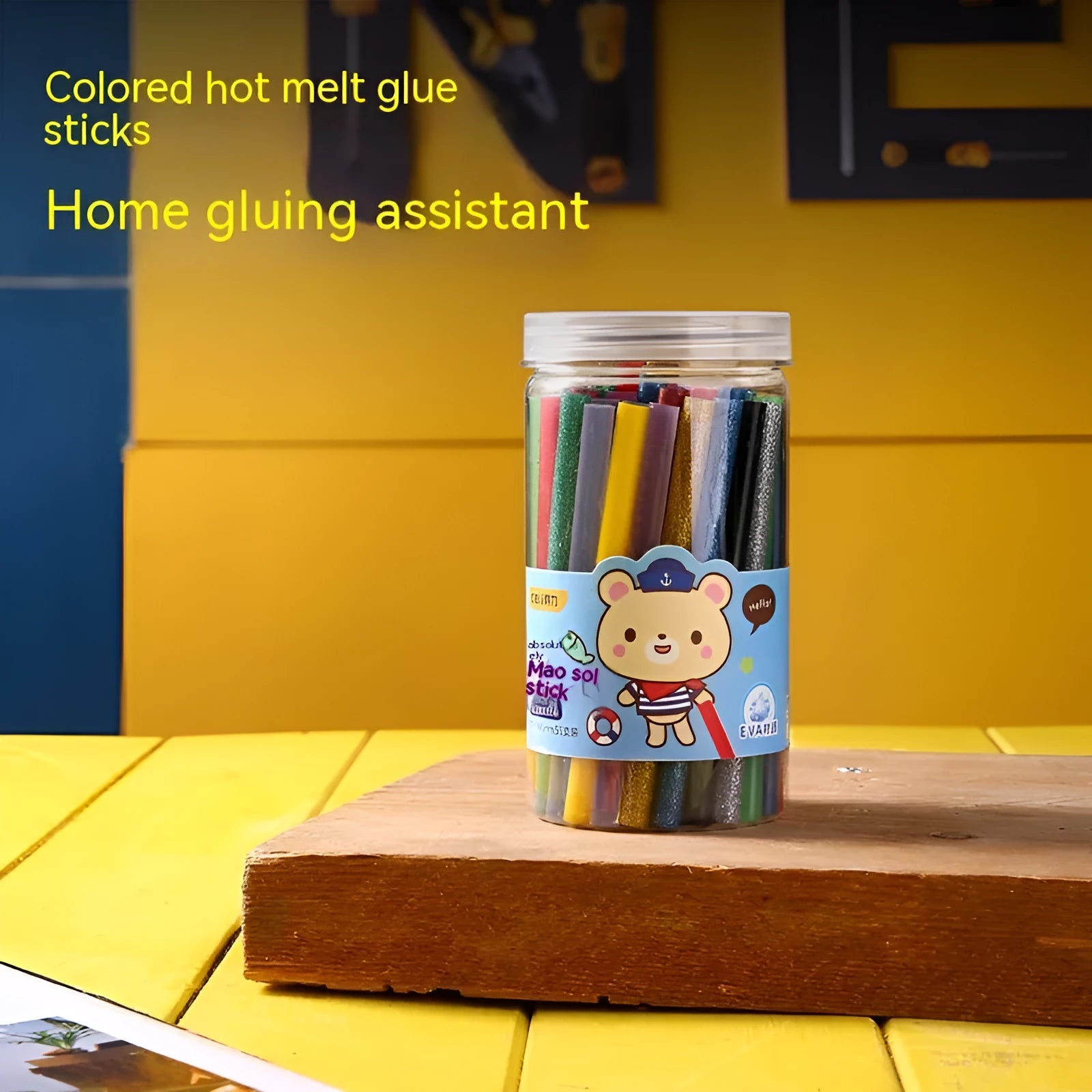 Pack of 55 clear hot melt glue sticks with 7mm diameter next to a glue gun