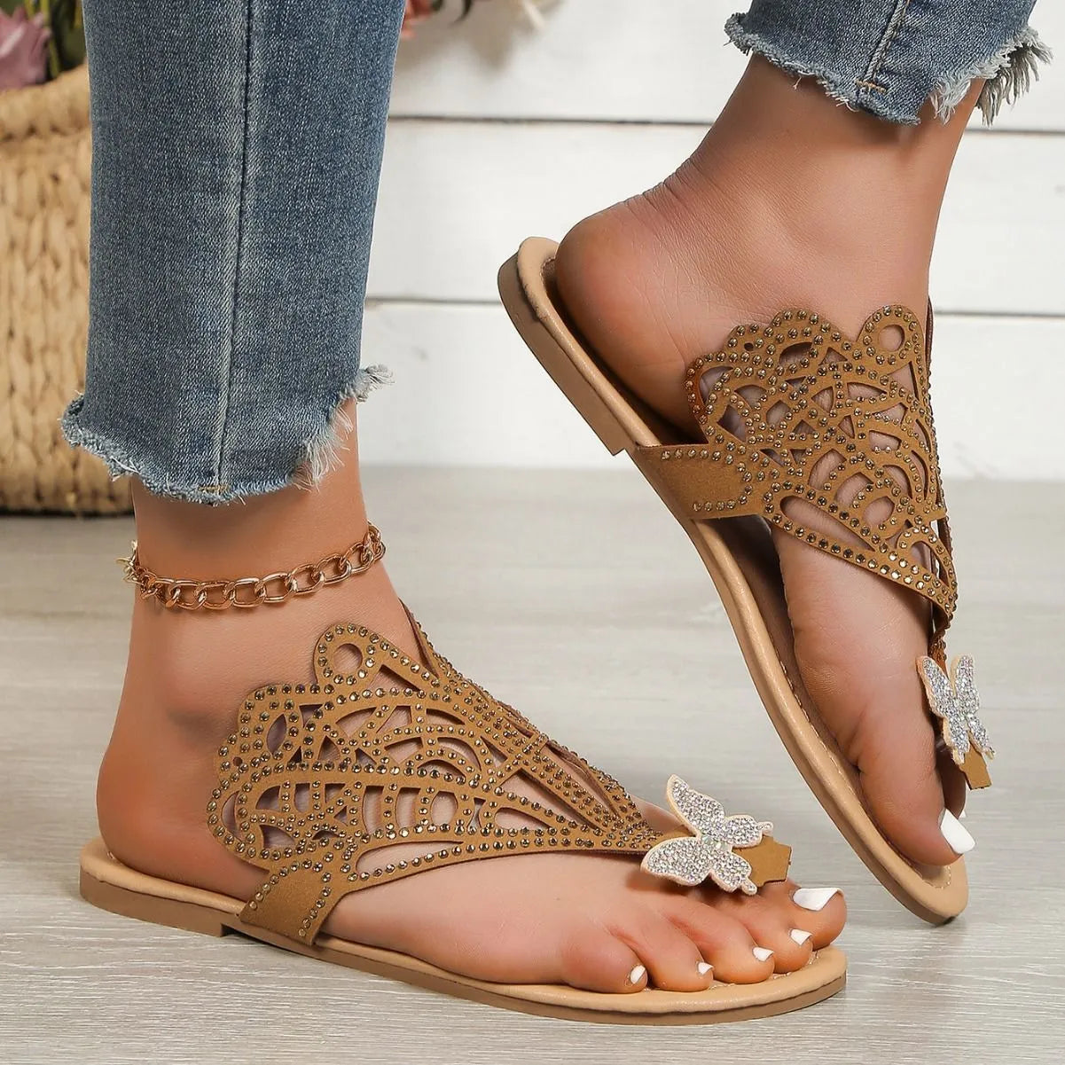 Black women's slip-on sandals with rhinestone detail and a flip-toe opening.