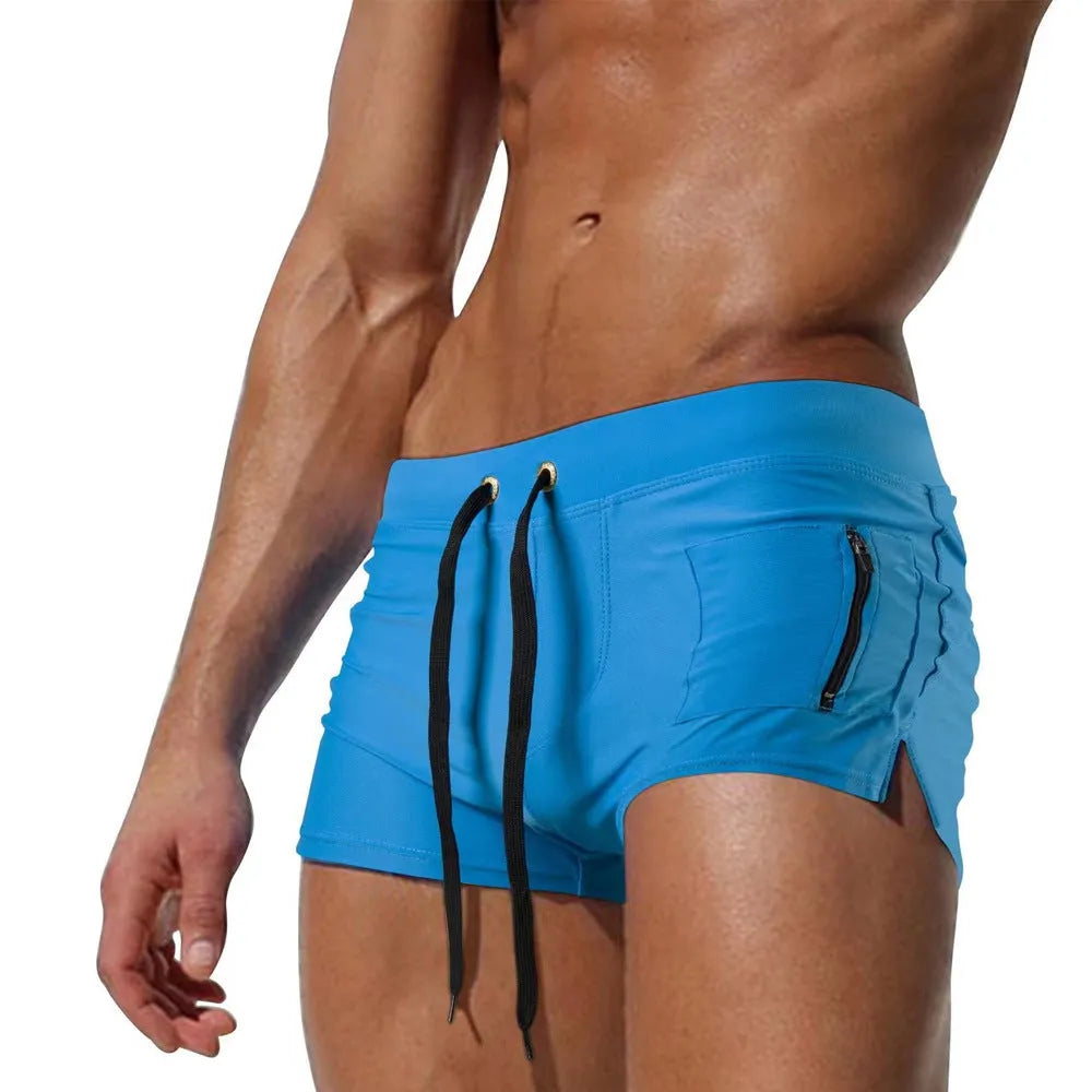 Men's high-waist black swimming trunks with a lace-up front, brief style, and spandex lining.