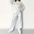 Casual polyester suit with zip hoodie and striped lace-up trousers in apricot colour.