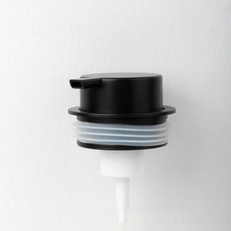 Foam pump bottle dispenser with large metallic pump head for facial cleanser.