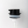 Foam pump bottle dispenser with large metallic pump head for facial cleanser.