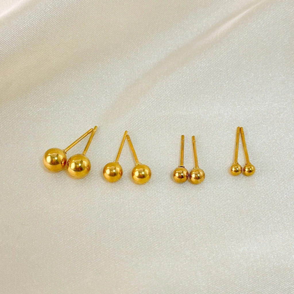 Stainless steel ball stud earrings in gold and silver tones showing 3mm to 6mm size variations