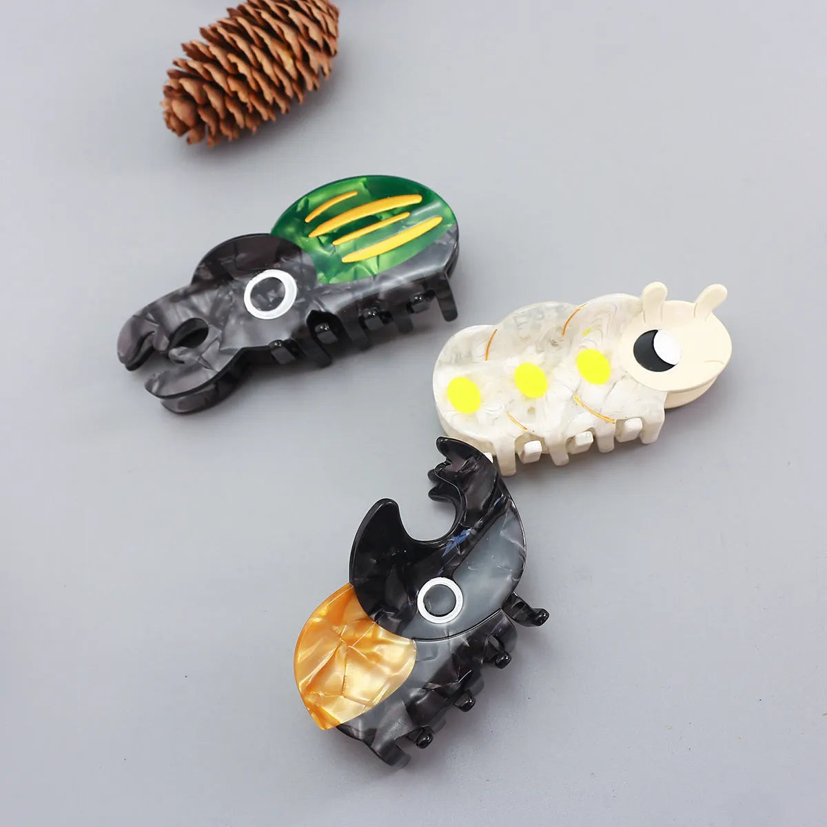 Cellulose acetate beetle grip with insect biology design in green, orange, or white colour options