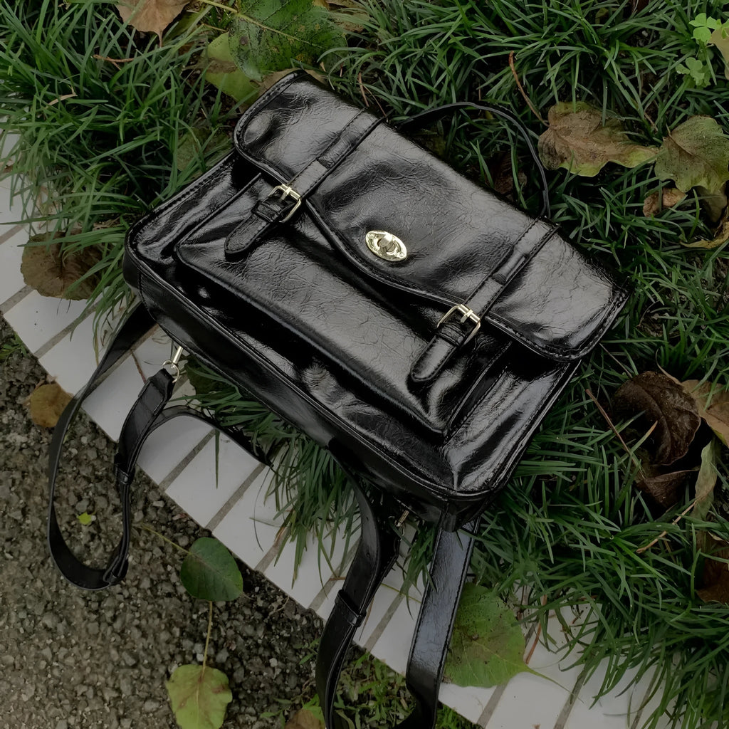 Black college style messenger bag made from oil wax leather PU material with dimensions of 35cm length