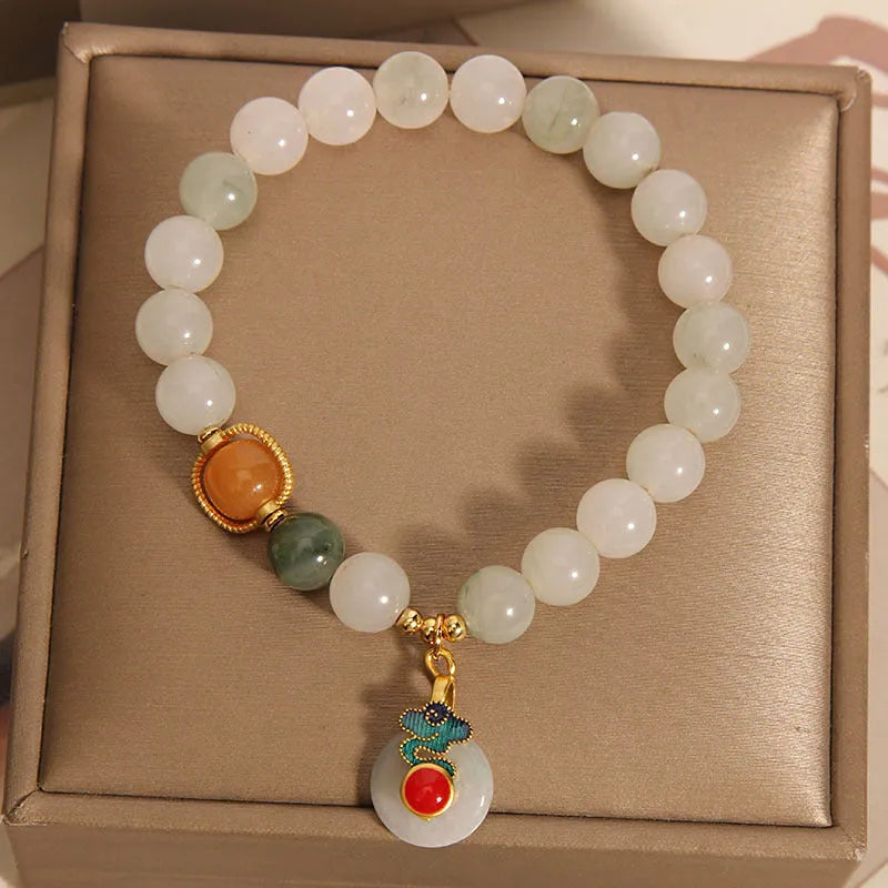 Women's ice jade crystal bracelet with a pearl detail and traditional Chinese jade buckle.